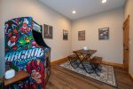 Downstairs Game Room with Arcade Game and Puzzle Table